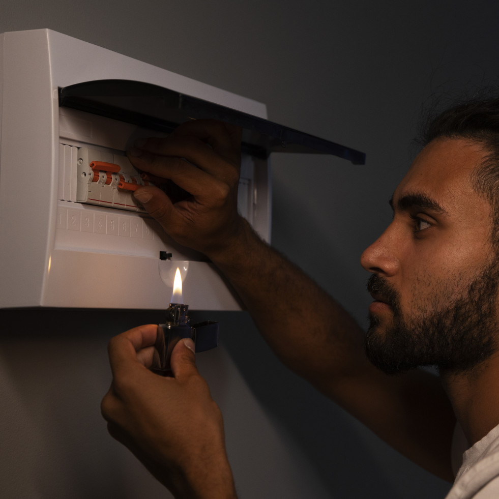 Side view man checking electrical panel
